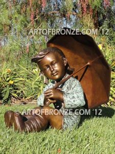 Summer Breeze bronze sculpture of cute young girl in the sun with umbrella