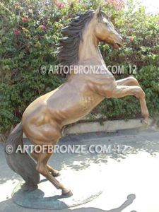 Thunderstorm sculpture of reared horse with forelegs off the ground and hind legs attached bronze base