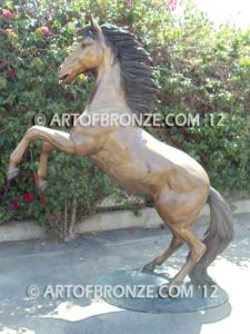 Thunderstorm sculpture of reared horse with forelegs off the ground and hind legs attached bronze base