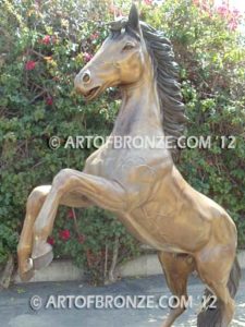 Thunderstorm sculpture of reared horse with forelegs off the ground and hind legs attached bronze base