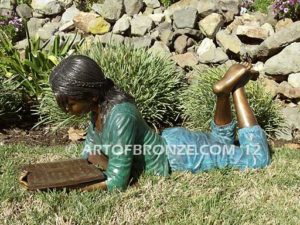 Best in Her Class other side bronze statue of girl lying down reading book