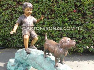 Adventurous Pals Bronze monumental sculpture for garden or yard of boy and dog crossing bronze log