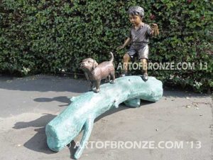 Adventurous Pals Bronze monumental sculpture for garden or yard of boy and dog crossing bronze log