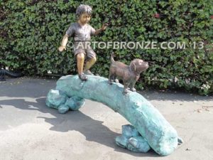 Adventurous Pals Bronze monumental sculpture for garden or yard of boy and dog crossing bronze log