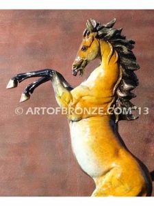 Sunfire sculpture of reared horse with contemporary brilliant patina coloring attached to marble base