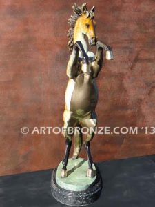 Sunfire sculpture of reared horse with contemporary brilliant patina coloring attached to marble base