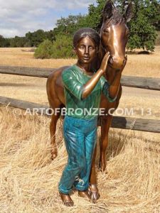 Dreams Come True bronze sculpture of girl petting her pony horse