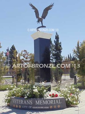 Eagle Veteran Memorial outdoor monumental statue of an eagle landing atop granite pillar