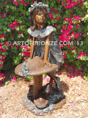 Wonderland bronze sculpture of giant mushroom and standing girl with frog