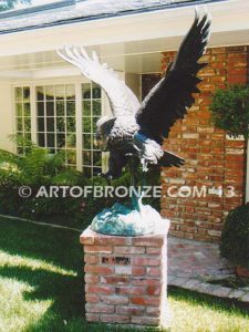 Owl lost wax casting of magnificent and powerful owl hunting on brick pedestal