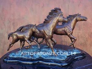 Wild & Free sculpture of charging horses and foal attached to a marble base