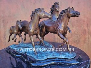 Wild & Free sculpture of charging horses and foal attached to a marble base