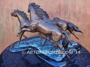 Wild & Free sculpture of charging horses and foal attached to a marble base