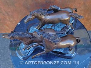 Wild & Free sculpture of charging horses and foal attached to a marble base