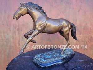 Running Free sculpture award of charging horse attached to a marble base