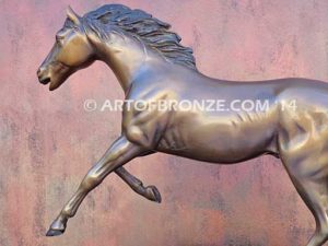 Running Free sculpture award of charging horse attached to a marble base