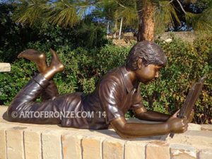 Best in His Class bronze sculpture of young boy reading his favorite novel