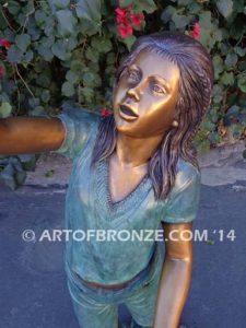 Faith bronze sculpture of young standing girl with doves in her hands