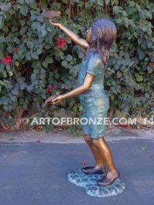 Faith bronze sculpture of young standing girl with doves in her hands