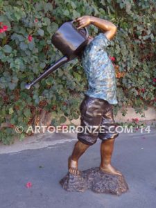 Strolling Along bronze sculpture of boy helping in garden watering flowers