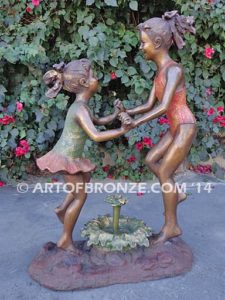 Dance Around bronze sculpture of two girls holding hands and dancing