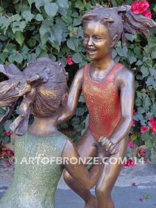 Dance Around bronze sculpture of two girls holding hands and dancing