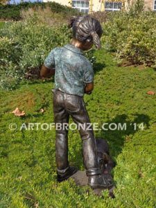 Play with Me Too bronze sculpture of girl holding dog with other dog chewing on her shoelace