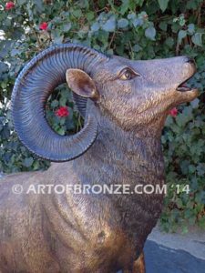 Clash of the Titans special edition, monumental outdoor rams clashing on bronze rock ledge