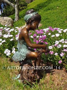 Blooming Youth side view A bronze sculpture of young ballerina sitting tying her slipper