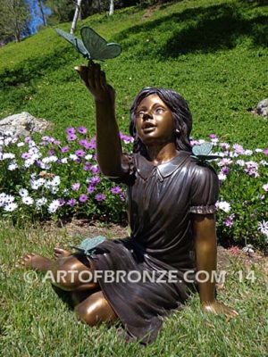 Wings of Joy bronze sculpture of sitting girl in dress with bronzes butterflies