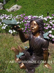 Wings of Joy bronze sculpture of sitting girl in dress with bronzes butterflies