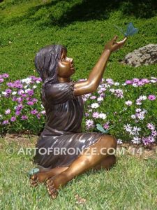 Wings of Joy bronze sculpture of sitting girl in dress with bronzes butterflies