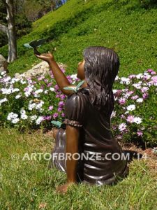 Wings of Joy bronze sculpture of sitting girl in dress with bronzes butterflies