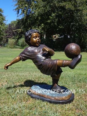 Lil Scorer sculpture of boy playing AYSO soccer bicycle kicking ball into goal