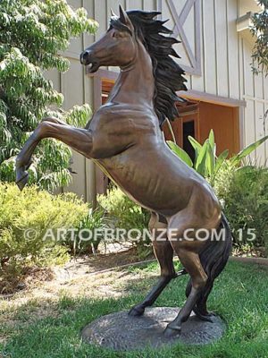 Thunderstorm sculpture of reared horse with forelegs off the ground and hind legs attached bronze base