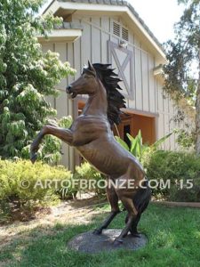 Thunderstorm sculpture of reared horse with forelegs off the ground and hind legs attached bronze base