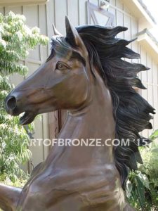 Thunderstorm sculpture of reared horse with forelegs off the ground and hind legs attached bronze base