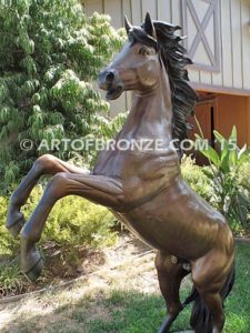 Thunderstorm sculpture of reared horse with forelegs off the ground and hind legs attached bronze base