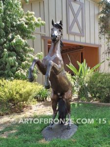 Thunderstorm sculpture of reared horse with forelegs off the ground and hind legs attached bronze base