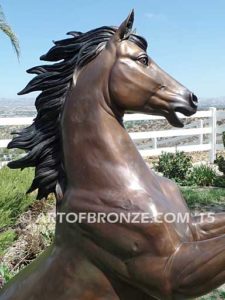 Thunderstorm sculpture of reared horse with forelegs off the ground and hind legs attached bronze base