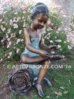 Blooming Youth bronze sculpture of young ballerina sitting tying her slipper