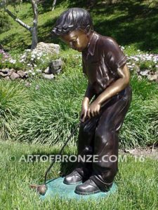 All Lined Up Bronze sports sculpture of golfer boy hitting ball with his putter