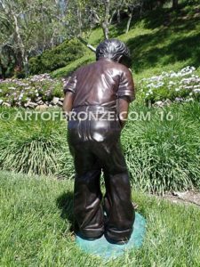 All Lined Up Bronze sports sculpture of golfer boy hitting ball with his putter