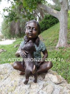 Give me Attention bronze statue girl sitting down playing with puppy dog on her lap