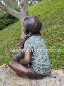 Give me Attention bronze statue girl sitting down playing with puppy dog on her lap