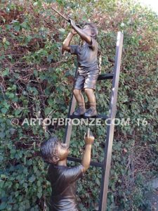 Team Work bronze sculpture of two boys climbing ladder working on house