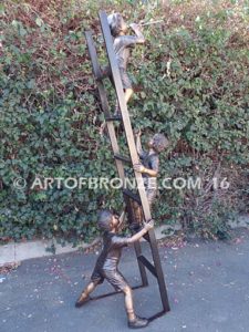 Team Work bronze sculpture of two boys climbing ladder working on house