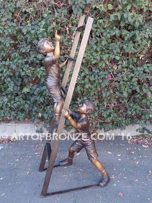 Team Work bronze sculpture of two boys climbing ladder working on house