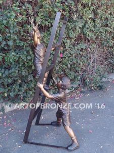 Team Work bronze sculpture of two boys climbing ladder working on house