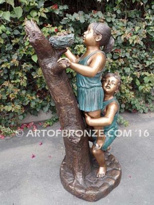 Baby Rescue Bronze Statue of kids playing together rescuing baby birds in tree